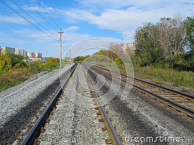 Railroad rails converge on the horizon Stock Photo