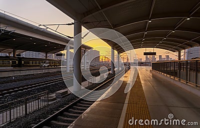 Railroad - Railway at sunset with sun Stock Photo