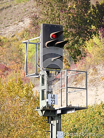 A railroad signal as a railroad traffic light stands on red Stock Photo