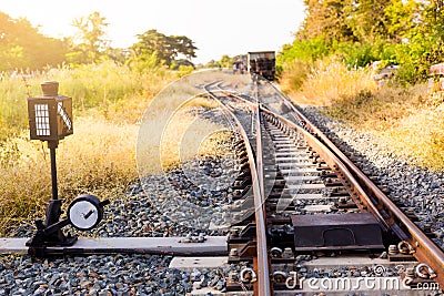Railroad switch with train in the morning sun. The conception of Stock Photo