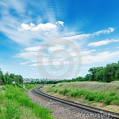Railroad to green horizon and clouds in blue sky Stock Photo