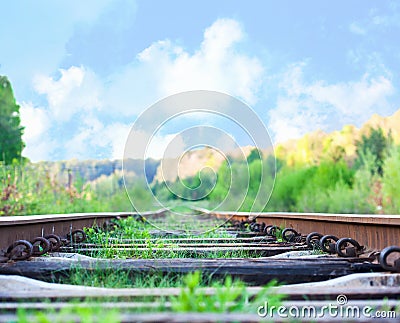 Railroad to horizon under deep blue sky in sunset Stock Photo