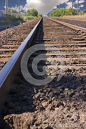 Railroad Tracks with Clouds in the Horizon Stock Photo