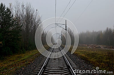 Railroad tracks in a misty haze after rain in the autumn Stock Photo