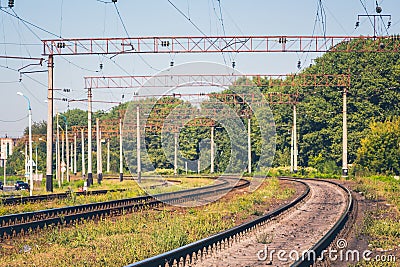 Railroad tracks of modern electrified railways near the forest_ Stock Photo
