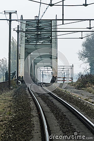 Rails and an old steel railway bridge Stock Photo