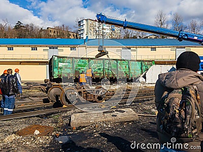 Railway accident. A crane lifts a wagon on a sunny day. Stock Photo