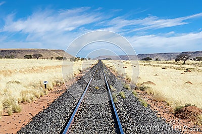 Railway in african savannah landscape, railroad in savanna grassland, Namibia, South Africa Stock Photo