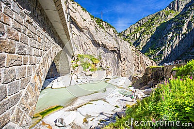 Railway bridge Teufelsbrucke over Reuss river in St. Gotthard mountain range of Swiss Alps near Andermatt Stock Photo