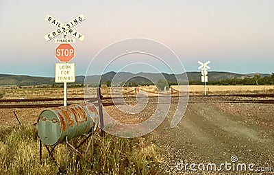 Railway crossing sign with Australian landscape. Stock Photo