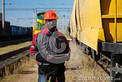 Railway employee holds in hands tablet pc and look at camera Stock Photo