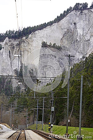 Railway and railroad on the bottom of Ruinaulta ravine or gorge of Anterior Rhine, Versam, Switzerland Stock Photo