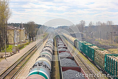 Railway stretches into the distance, three freight trains. carry Stock Photo