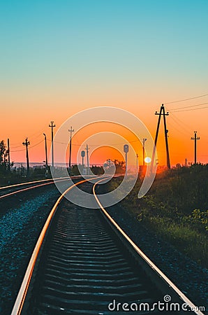 Railway at summer sunset. Vertical scenic view Stock Photo