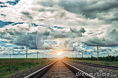 Railway at sunset with dramatic sky. Railroad track. Stock Photo