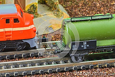 Railway tanker truck. Train hobby model on the model railway. Railroad platforms for transporting of liquid goods and Editorial Stock Photo