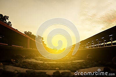 railway track on gravel for train transportation and light sunset in the morning. Stock Photo