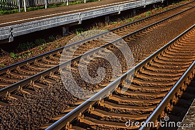 Railway track. Metallic rails and sleepers. Close-up. Travel and tourism. Background. Space for text Stock Photo