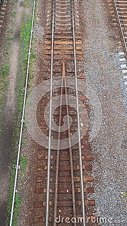 Railway Tracks Merging Into Single Line, Creating Intersection Point for Trains Stock Photo