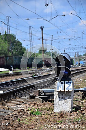 Railway traffic light semaphore against the background of a day railway landscape. Signal device on the railway trac Stock Photo