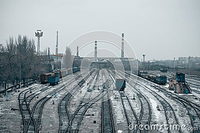 Railway with trains and plant in the background. Wagon depot. Rails Stock Photo