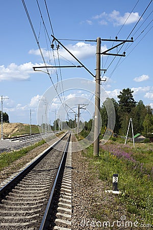 A railway under blue sky with clouds of white Stock Photo