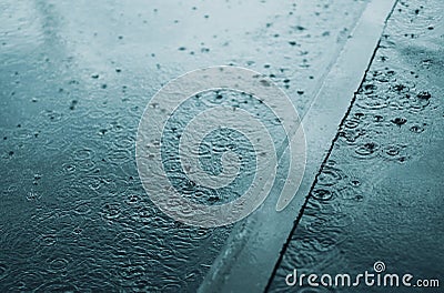 Rain, autumn, weather concept - puddle and splashing water in rainy evening Stock Photo