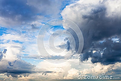 Rain clouds block the sun in blue sky Stock Photo