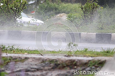 Rain droplets drifted up after a vehicle passed Stock Photo