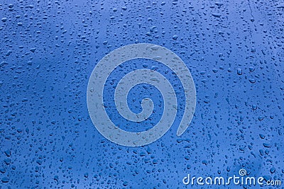 Rain drops on a blue vehicle bodywork. Wet background Stock Photo
