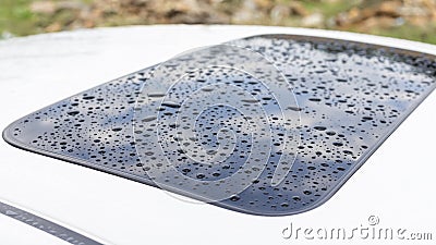 Rain drops on sunroof of a car. Selective focus Stock Photo