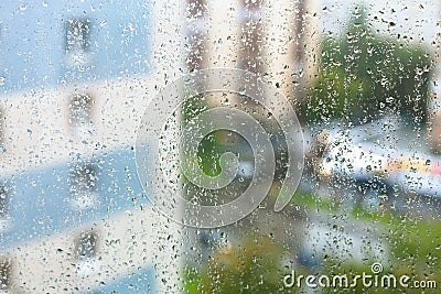 rain drops on windowpane and blurred city Stock Photo