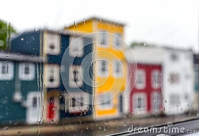 Rain drops on windows with jellybean houses in Newfoundland Stock Photo