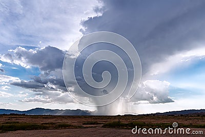 Rain falling from a storm cloud Stock Photo