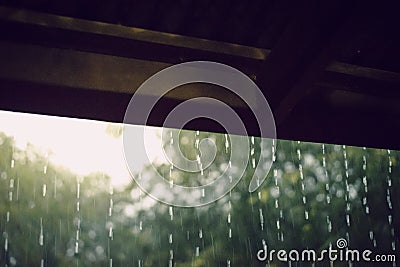 Rain from the roof of the wooden house Stock Photo