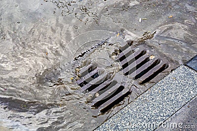 Rain flowing into a storm water sewer system Stock Photo