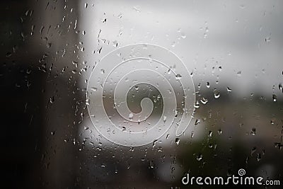 Rain on glass. Raindrops on window glass. Selective focus. Rainy city background Stock Photo