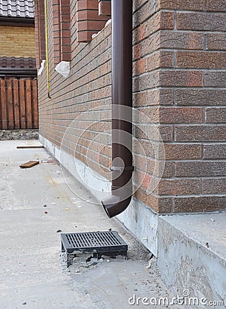 Rain Gutter Installation with Rainwater Drainage System Installation. Drainage System in Building Stock Photo