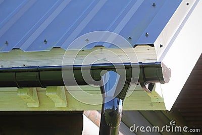 Rain Gutter Pipeline System Installation. Roofing Construction. Rain gutter system and roof protection from snow . Home Guttering Stock Photo