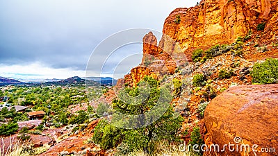 Rain pouring down on the geological formations of the red sandstone buttes surrounding the Chapel of the Holy Cross at Sedona Stock Photo