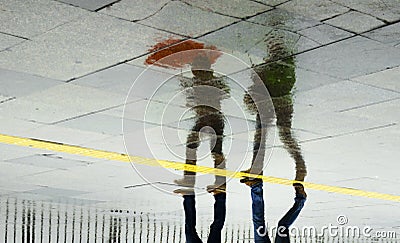 Rain reflection umbrella Two women walking in the rain Stock Photo