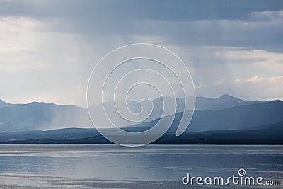 Rain shower over Marsh Lake Yukon Territory Canda Stock Photo