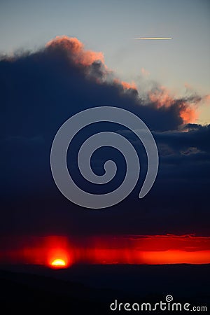 Rain, sunset and a plane Stock Photo