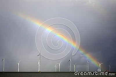 Rainbow above a offshore windpark, Holland Stock Photo