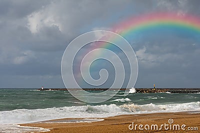 Rainbow on the beach of Anglet after the storm Stock Photo