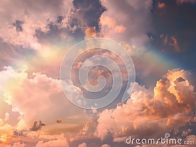 Rainbow at blue pink sunset sky fluffy clouds and sunlight beams skyline nature landscape weather forecast Stock Photo