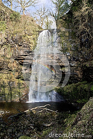 Rainbow caught in Sgwd Henrhyd; henrhyd Waterfall Stock Photo