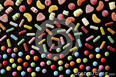 Rainbow colored assorted sweets on black Stock Photo