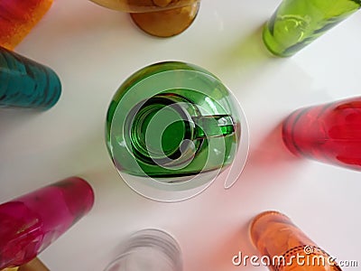 rainbow colored bottles. with big green jug in middle. diversity, acceptance, gay pride, Lifesaver colors Stock Photo