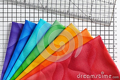 Rainbow colored quilting fabrics set, cutting mat and quilting ruler Stock Photo